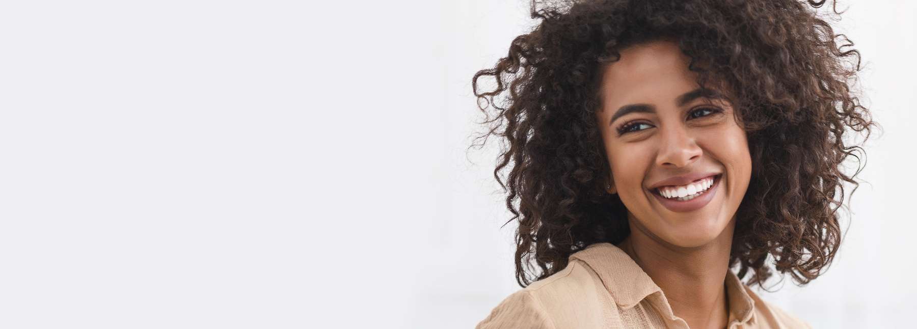 woman with curly hair smiling | dentist in medina oh